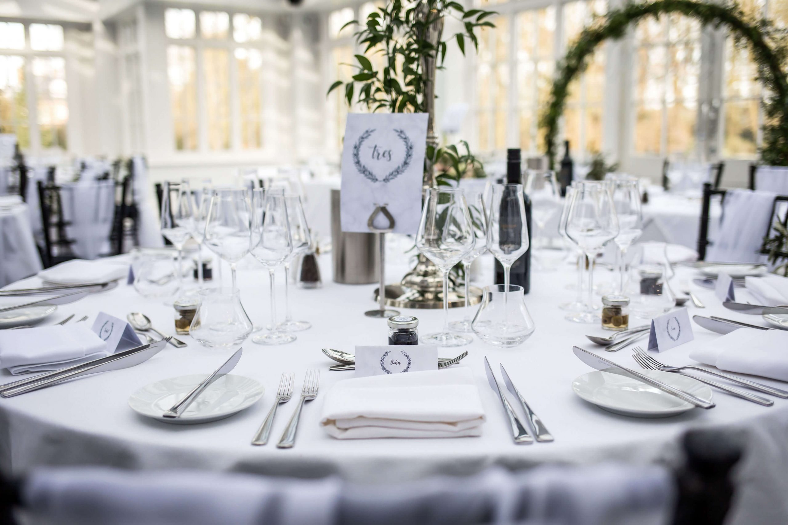 Crisp white linen table cloths with gleaming white crockery, sparkling glassware and polished cutlery on tables at Swynford Manor